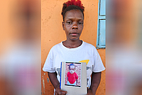 Ms Florence Wanjiku holding the portrait of her late daughter, Elizabeth Wamaitha