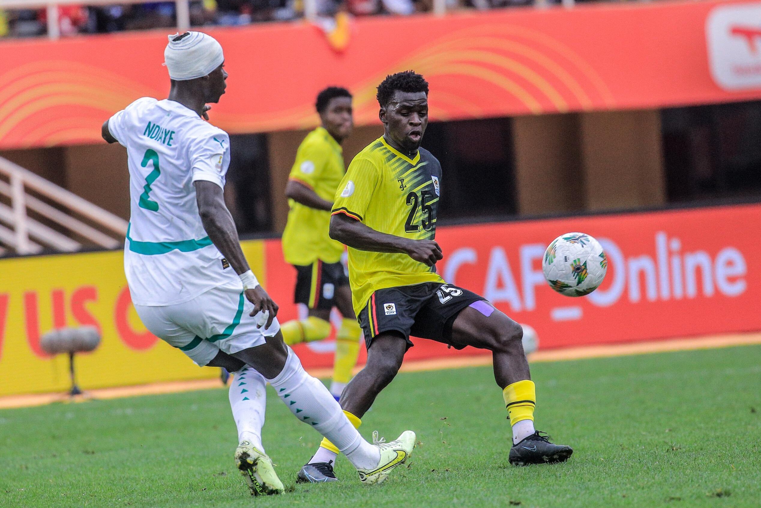 Senegal's Seyni Ndiaye shoots the ball past Ugandan player during their CHAN 2024 quarter-final match