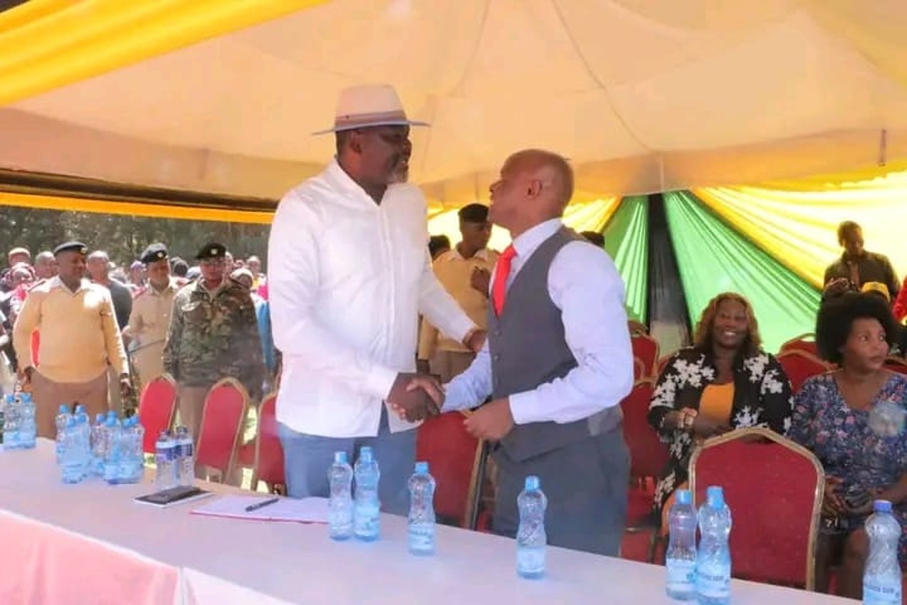 Public Service, Human Capital Development and Special Programmes CS Geoffrey Ruku (left) is welcomed by Kangundo MP Fabian Kyule on Friday at Kangundo D.E.B. Primary School grounds during the launch of the school feeding programme in the region. The CS also said the government has rolled out a series of emergency measures to support communities affected by floods following recent heavy rains across some parts of the country.