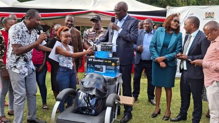 Some of the beneficiaries of the MSEA programme get a machine from director General Mwenda Rithaa (in googles) in Meru