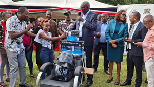 Some of the beneficiaries of the MSEA programme get a machine from director General Mwenda Rithaa (in googles) in Meru