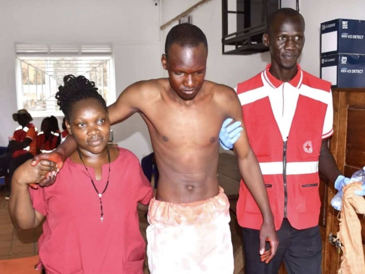 Dennis Zziwa (centre) getting medical assistance after he sustained injuries after Jesus reenactment lashes.