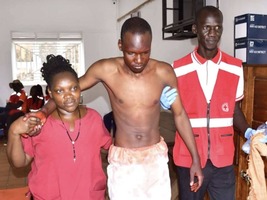 Dennis Zziwa (centre) getting medical assistance after he sustained injuries after Jesus reenactment lashes.