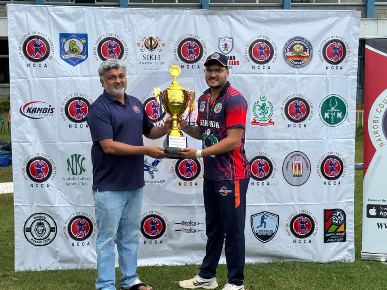 Nairobi County Cricket Association (NCCA) chairman Kanti Rabadia (left) presents the NCCA T20 title to Swamibapa skipper Sachin Gilll.