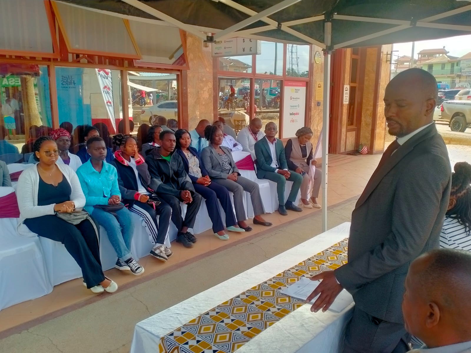 Equity Bank Tala Branch Manager, Mr Stephen Mutua, speaking during the flagging-off ceremony for beneficiaries in Tala town. He noted that the beneficiaries were top-performing students who achieved A and A- grades in their KCSE examinations