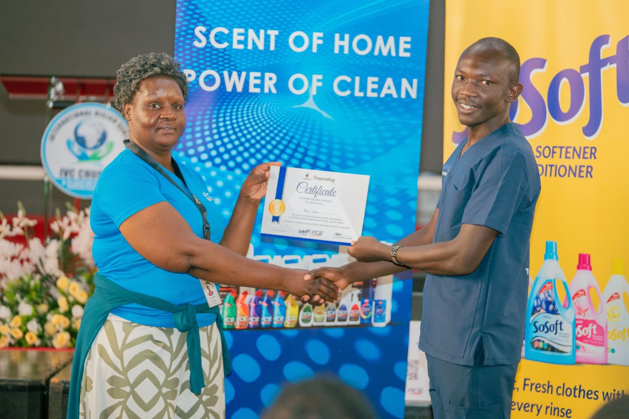 HACO Industries Homecare Category Manager, Joan Chege (left) presenting a certificate to Brian Juma, a participant, after a successful completion of a training